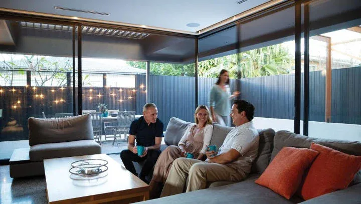 Four Adults Sitting Happily in A Living Room
